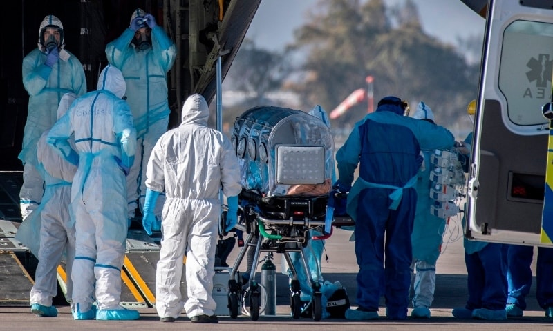 Health workers move a Covid-19 infected patient in Chile on May 24. &mdash; AFP
