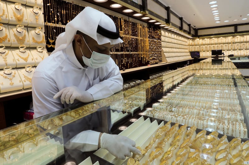 FILE PHOTO: A Saudi jeweller wearing a protective face mask arranges gold jewels at a jewellery store during the holy month of Ramadan, after the outbreak of the coronavirus disease (COVID-19), in Riyadh, Saudi Arabia, May 5, 2020. REUTERS/Ahmed Yosri/File Photo