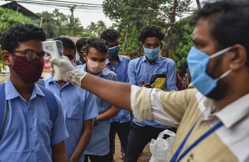 School children wearing masks get their hands sanitised and temperatures checked as they arrive to appear for state board examination during the coronavirus pandemic in Kochi, Kerala state in India on Tuesday, May 26, 2020. — AP