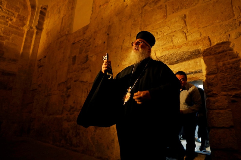 The head of the Greek Orthodox Church in Bethlehem, bishop Theophylactos, holds a key as he reopens the Church of the Nativity after Palestinians ease restrictions of the coronavirus disease (COVID-19), in Bethlehem in the Israeli-occupied West Bank May 26, 2020. REUTERS/Mussa Qawasma     TPX IMAGES OF THE DAY