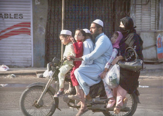 A MAN rides the overloaded motorbike as part of Eid celebrations, risking his and family’s lives.—Online