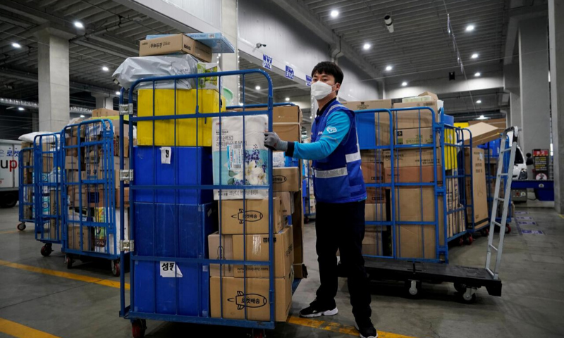 File picture of a delivery man for Coupang wearing a mask to prevent contracting the coronavirus, loading packages before leaving to deliver them in Incheon, South Korea. — Reuters