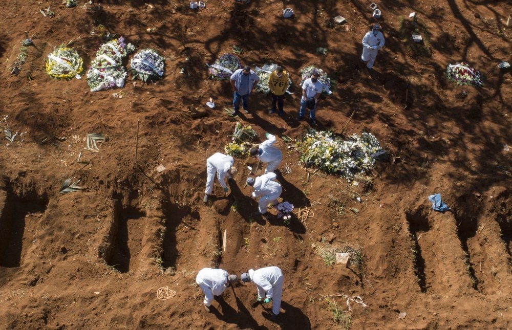 In this May 20 file photo, cemetery workers in protective clothing bury a Covid-19 victim at the Vila Formosa cemetery in Sao Paulo, Brazil. Even amid a global pandemic, there’s no sign that corruption is slowing down in Latin America. — AP