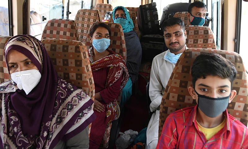 Pakistani nationals sit inside a mini bus before crossing the India-Pakistan Wagah border post. &mdash; AFP