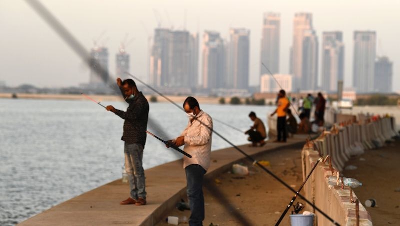 Men gather to fish at the creek in the Gulf city of Dubai, after the Emirati authorities eased some of the restrictions that were put in place in a bid to stem the spread of the novel coronavirus, on May 27, 2020. - The Emirati (Photo by Karim SAHIB / AFP) &mdash; AFP or licensors