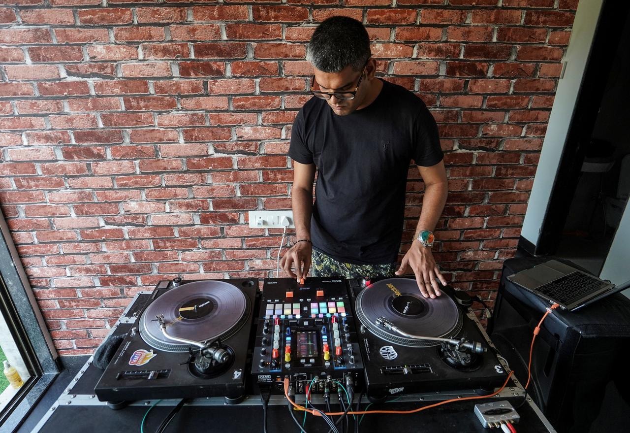 Sanjay Meriya plays music inside his home after returning from a temporary health centre where he coaches slum dwellers on the precautions they should take to avoid being infected with Covid-19, in Mumbai, India, May 25. &mdash; Reuters