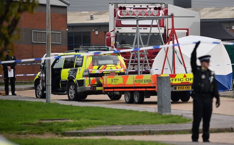(FILES) In this file photo taken on October 23, 2019, police officers work at the scene where a lorry, believed to have originated from Bulgaria, and found to be containing 39 dead bodies, was discovered at Waterglade Industrial Park in Grays, east of London. - A man suspected of being the organiser of the Vietnamese migrant smuggling network that smuggled into England a refrigerated lorry in which 39 people were found dead in October 2019 was arrested on May 27, 2020, in Germany, AFP learned on May 29, 2020, from corroborating sources. Twenty-six arrests also took place on May 26 in France (FILES) In this file photo taken on October 23, 2019, police officers work at the scene where a lorry, believed to have originated from Bulgaria, and found to be containing 39 dead bodies, was discovered at Waterglade Industrial Park in Grays, east of London. - A man suspected of being the organiser of the Vietnamese migrant smuggling network that smuggled into England a refrigerated lorry in which 39 people were found dead in October 2019 was arrested on May 27, 2020, in Germany, AFP learned on May 29, 2020, from corroborating sources. Twenty-six arrests also took place on May 26 in France