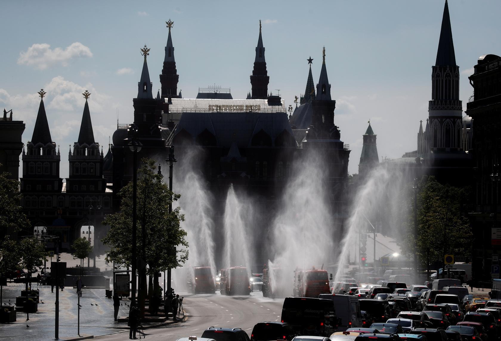 Vehicles spray disinfectant while sanitising a road in Moscow, Russia, May 28. — Reuters