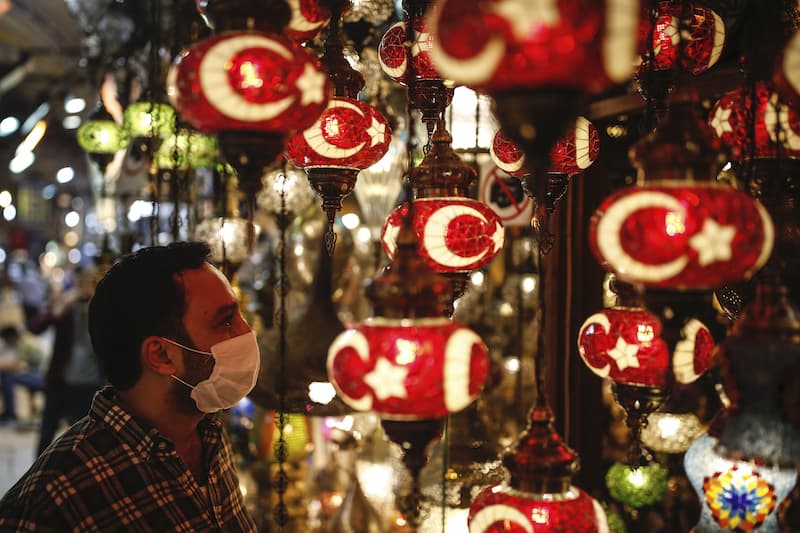 A customer, wearing a protective face mask looks at Turkish traditional lanterns at the iconic 15th century Grand Bazaar in Istanbul as it reopens on Monday, June 1, 2020, following weeks of closure due to the coronavirus pandemic. — AP