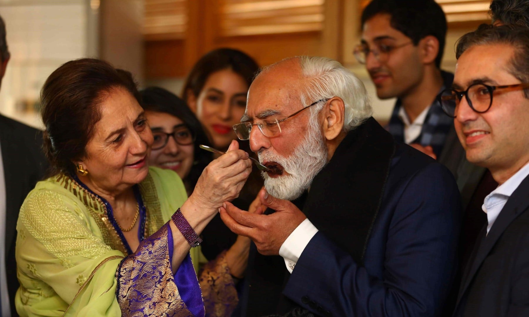 This handout picture taken on March 26 and received as a courtesy of the Adil Rahman family shows Fazal Rahmaan (2R) celebrating his 80th birthday with his wife Wahida Fazal Rahmaan in Lahore. — AFP