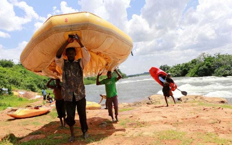 Men carry rafts and kayaks used during white water rafting at Itanda falls on the River Nile near Jinja district, 109km east of the Ugandan capital of Kampala, October 19, 2013. &mdash; Reuters