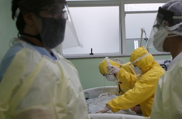Nurses prepare to transport a patient from an emergency health centre to a hospital in Santo Andre, Brazil, May 12. &mdash; Reuters