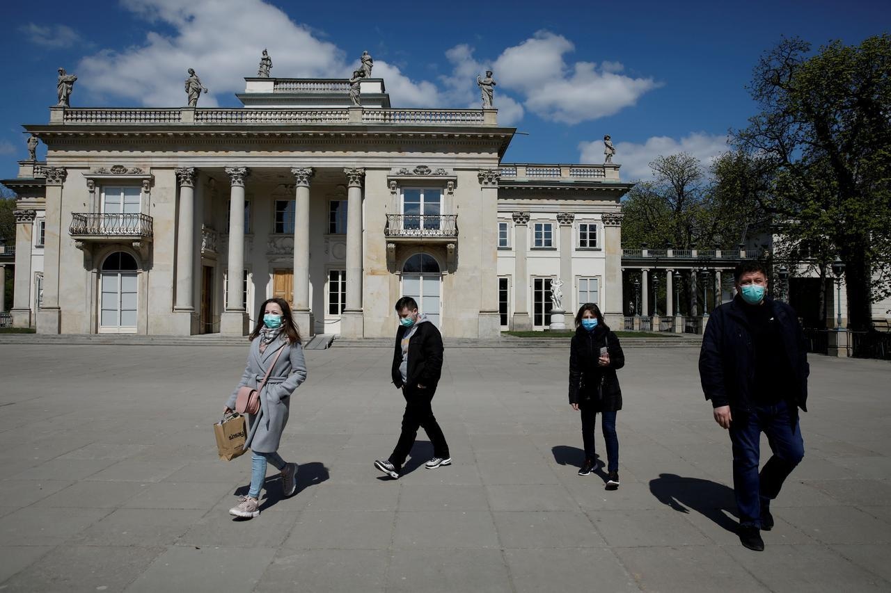 People wearing protective masks enjoy walking in the Lazienki Royal Park after loosening of the lockdown measures by the government, Warsaw, Poland. &mdash; Reuters