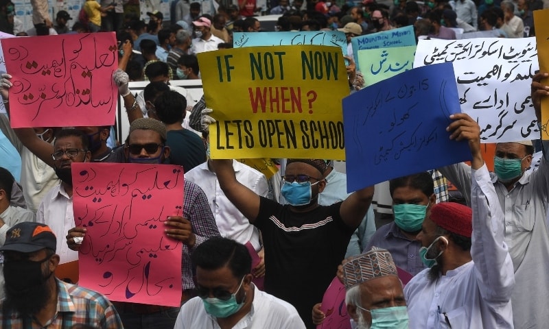 Protesters hold placards during the protest in Karachi. &mdash; AFP