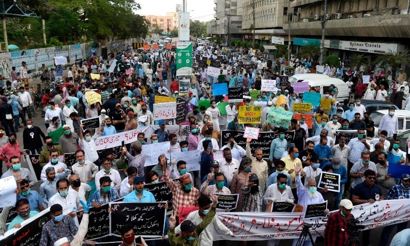 Members of the All Private Schools Association hold placards during a protest demanding the government to open private schools despite the Covid-19 crisis, in Karachi on June 10. &mdash; AFP
