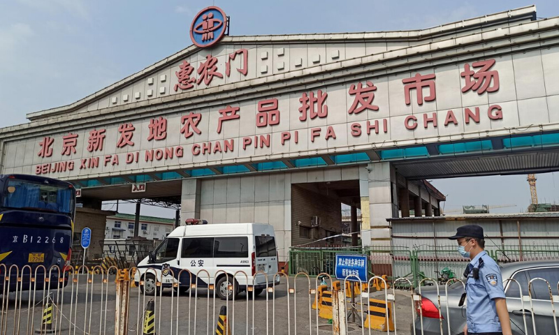 A police officer wearing a face mask is seen outside an entrance of the Xinfadi wholesale market, which has been closed for business after new coronavirus infections were detected. — Reuters