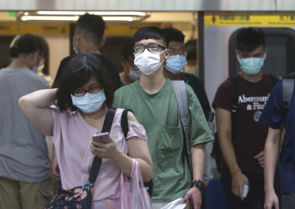 People wear face masks to protect against the spread of the coronavirus as they ride the subway in Taipei, Taiwan, Saturday, June 13. &mdash; AP