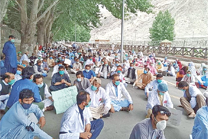 Health professionals stage a sit-in outside the GB Chief Minister’s House in Gilgit on Monday.—Dawn