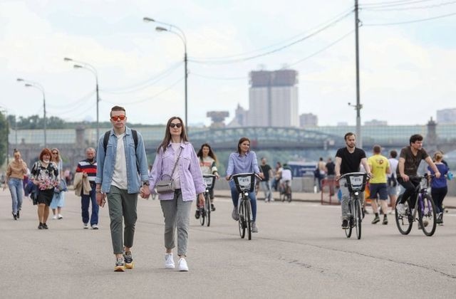 People walk and ride bicycles along an embankment of the Moskva River in Moscow, Russia, June 6. &mdash; Reuters
