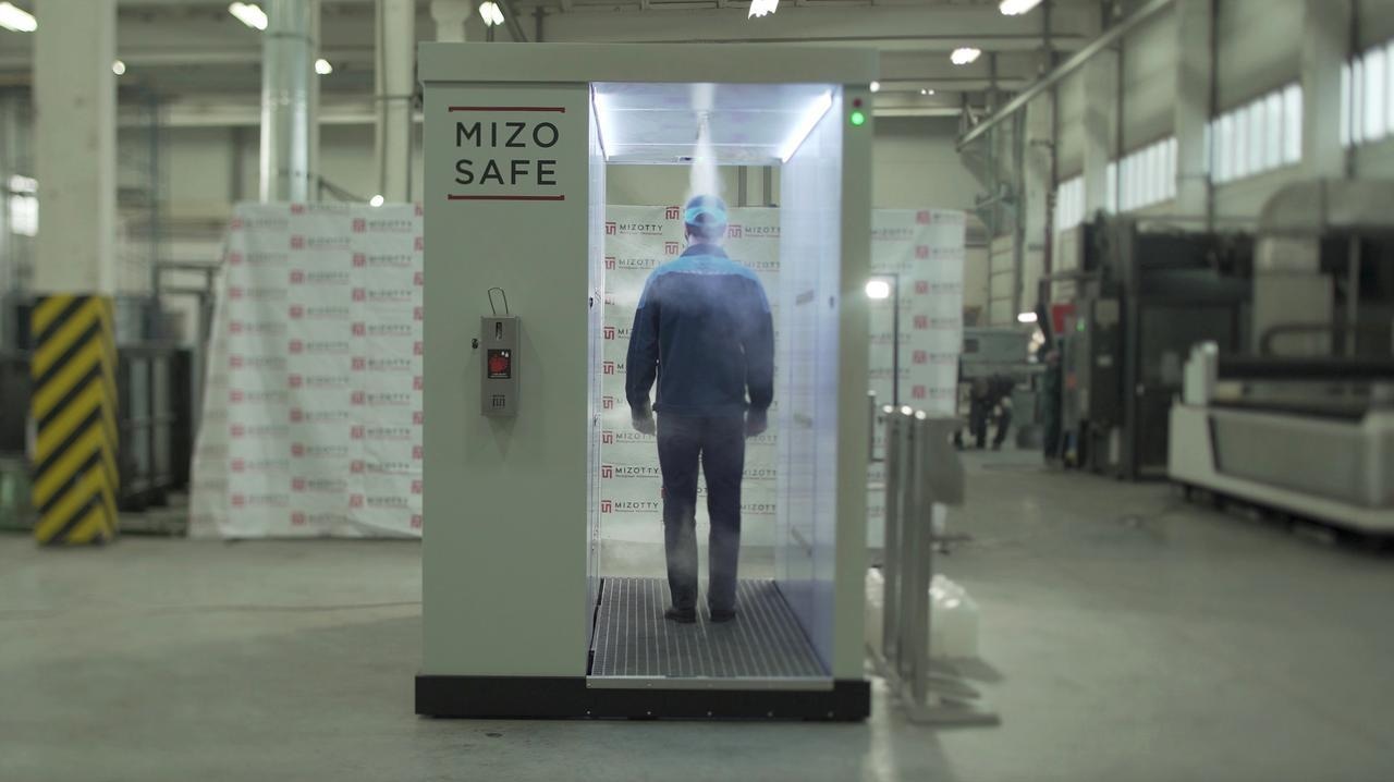 An employee walks through a disinfection tunnel manufactured by Russian company Mizotty at the company's factory in Penza, Russia. &mdash; Reuters