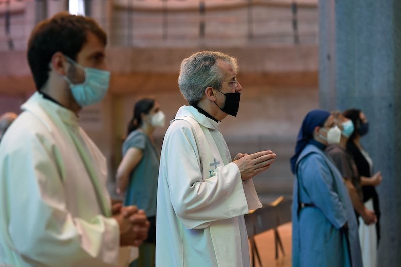 Priests and other members of the religious community attend the celebration of the first mass after the national lockdown to prevent the spread of the Covid-19 disease, at the Sagrada Familia basilica in Barcelona on June 19, 2020. — AFP
