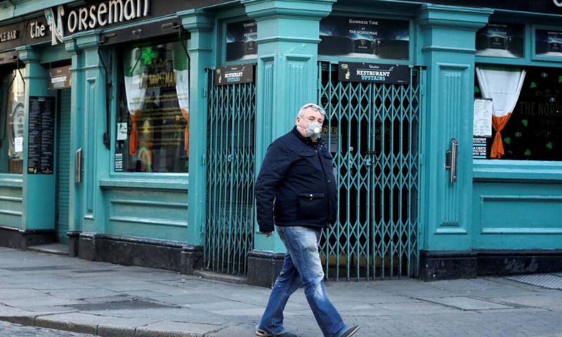 A man wearing a protective face mask passes The Norseman pub, as bars across Ireland close voluntarily to curb the spread of coronavirus in Dublin, Ireland on March 15. — Reuters/File