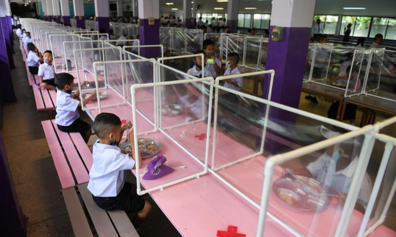 Students from the Wichuthit school eat their lunch after the Thai government eased isolation measures and introduced social distancing to prevent the spread of the coronavirus in Bangkok, Thailand. &mdash; Reuters