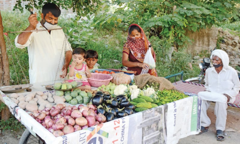 Health officials visit a slum in G-7 to test the residents for Covid-19. The other picture shows Razzaq Masih and his wife selling vegetables in the area. — White Star