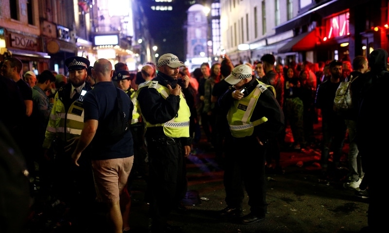 Police on patrol as people gather in Soho as restrictions are eased following the outbreak of the coronavirus disease in London on July 4. &mdash; Reuters