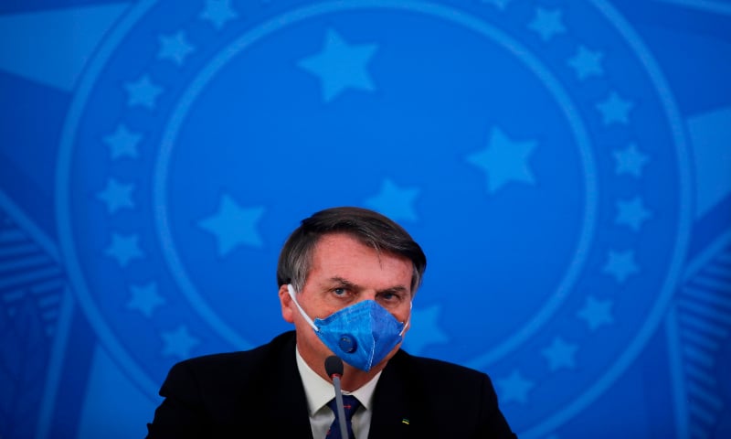 In this file photo taken on March 20, 2020, Brazil's President Jair Bolsonaro wears a face mask during a press conference on the coronavirus pandemic at the Planalto Palace in Brasilia, Brazil. &mdash; AFP