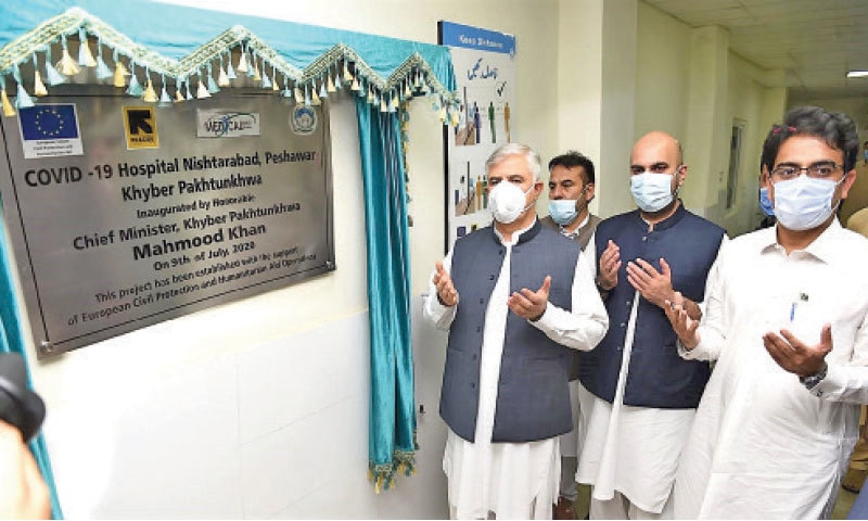 Chief Minister Mahmood Khan and others pray after the inauguration of a coronavirus hospital in Nishtarabad, Peshawar, on Thursday. &mdash; White Star
