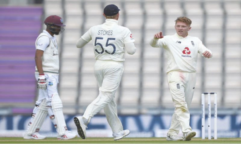 SOUTHAMPTON: England off-spinner Dom Bess (R) celebrates with stand-in captain Ben Stokes after taking the wicket of West Indies batsman Jermaine Blackwood during the first Test at the Ageas Bowl on Friday.—AP