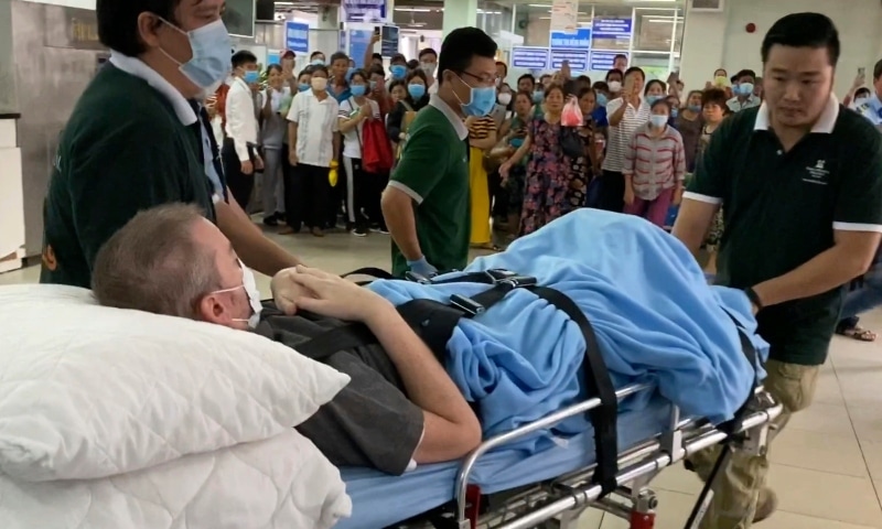 A British pilot who was Vietnam's most critical Covid-19 patient is carried on a stretcher in Ho Chi Minh City, Vietnam, Saturday. — AP