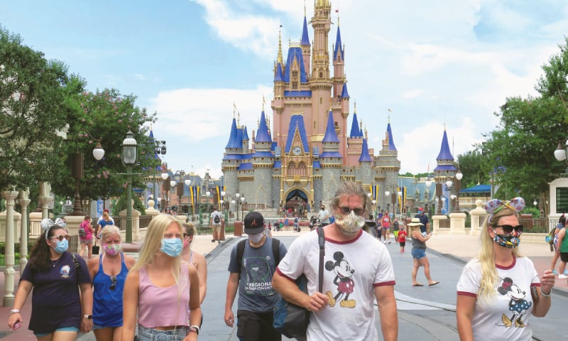 MIAMI (US): Guests wear mandatory masks during the reopening day of the Magic Kingdom at Walt Disney World in Lake Buena Vista.—AP