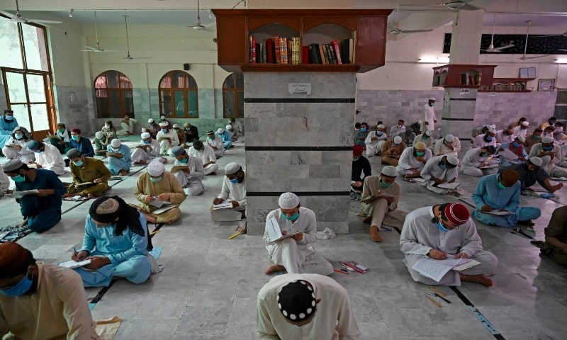 Students wearing facemasks as a preventive measure against the spread of the Covid-19, attend their final examination at the Jamia Muhammadia seminary in Islamabad on July 13, 2020. &mdash; AFP