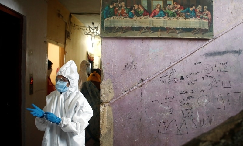 A health worker in personal protective equipment gets ready before the start of a check up campaign for the coronavirus disease at a housing society in Mumbai on July 17. — Reuters