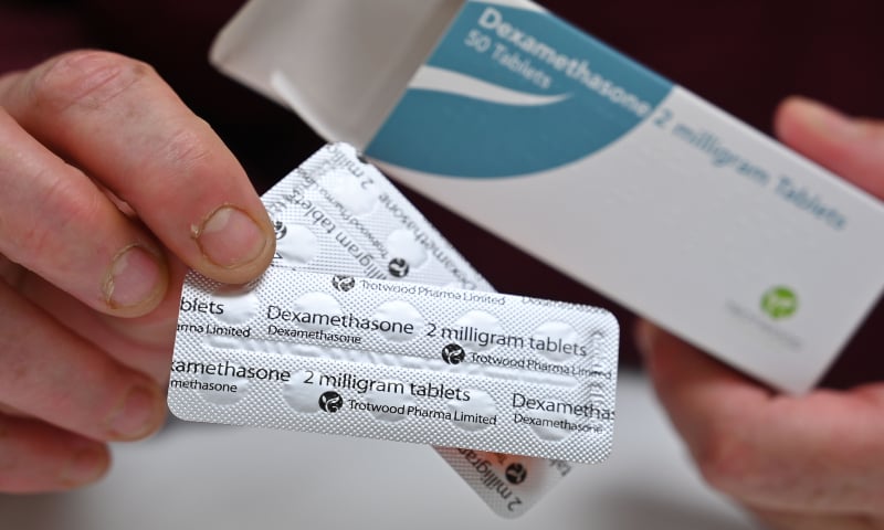 In this file photo taken on June 16, 2020, a pharmacist holds a box of dexamethasone tablets at a chemists shop in London. &mdash; AFP