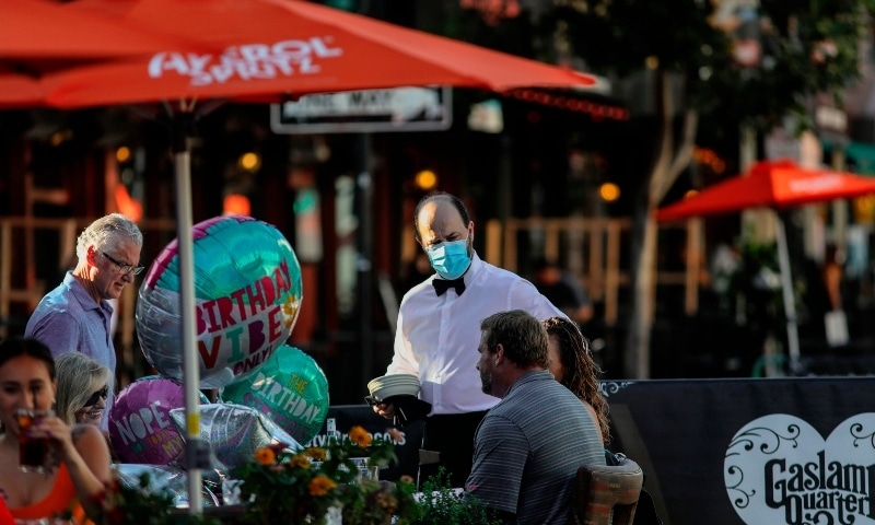 Patrons dine at an outdoor restaurant in downtown San Diego, California on July 17. — AFP