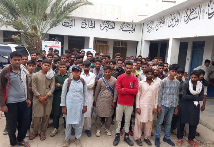Dalbandin: Illegal migrants aiming to move towards European countries pictured at the police station here on Wednesday.—Dawn