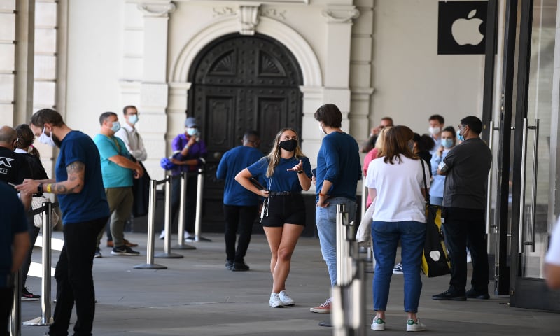 Shoppers wear face masks in Covent Garden, central London on July 24, 2020, as lockdown restrictions continue to be eased during the Covid-19 pandemic. — AFP