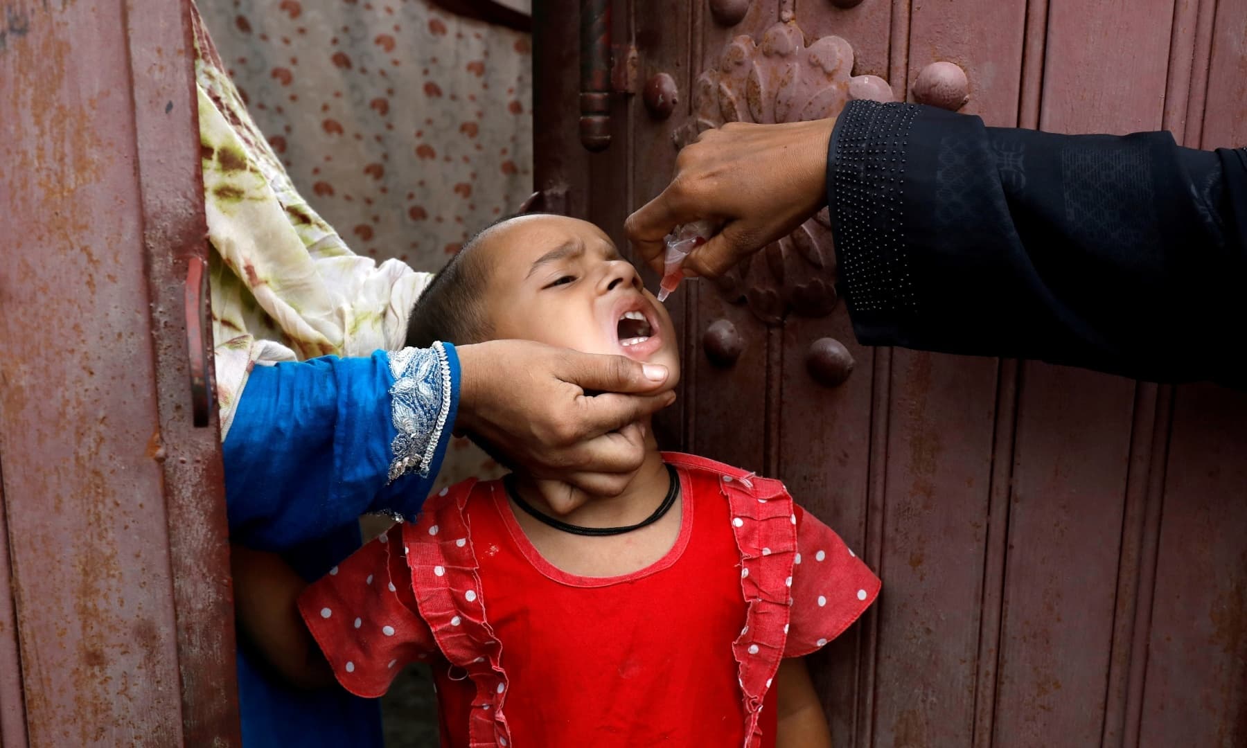 A girl receives polio vaccine drops during an anti-polio campaign in Karachi, July 20. — Reuters