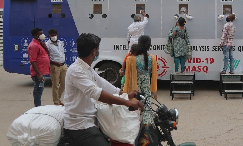 Indians get their nasal swab sample taken for Covid-19 test at a mobile testing centre in Hyderabad, India, July 27. — AP
