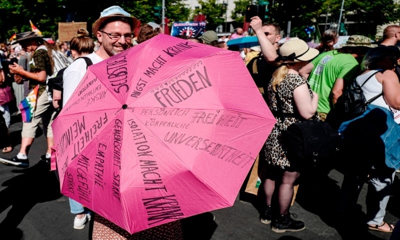 A participant holds an umbrella ahead a demonstration by the initiative &ldquo;Querdenken-711&rdquo; with the slogan &ldquo;the end of the pandemic-the day of freedom&rdquo; to protest against the current measurements to curb Covid-19 spreading in Berlin, on August 1, 2020. &mdash; AFP