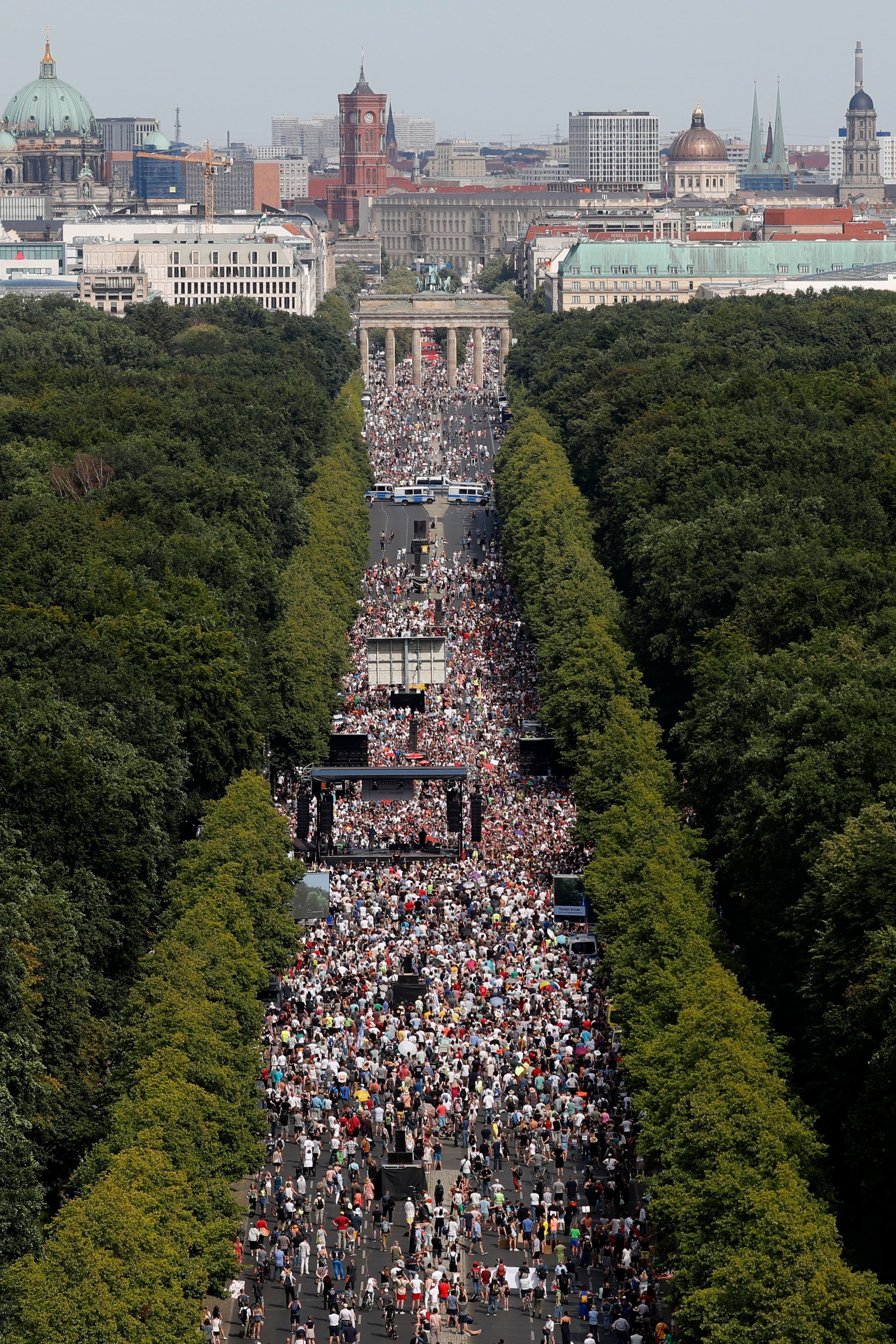 People gather at the Brandenburg gate for a demonstration in Berlin, Aug 1. — AP