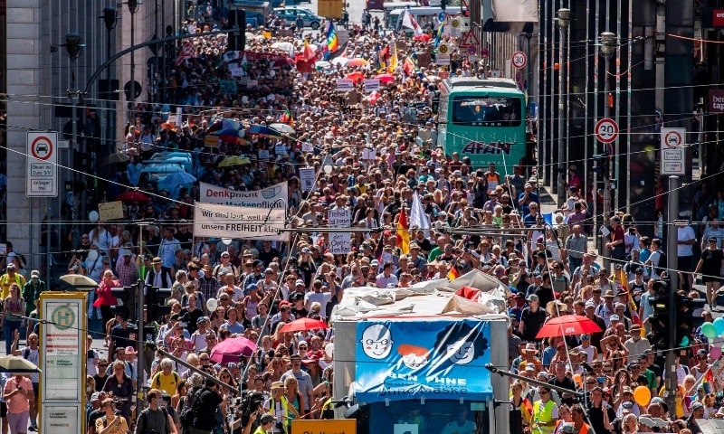 Thousands of demonstrators march down the Friedrichstrasse street as they take part in a demonstration by the initiative “Querdenken-711” with the slogan “the end of the pandemic-the day of freedom” to protest against the current measures to curb the spread of the Coronavirus, in Berlin, on August 1. — AFP Thousands of demonstrators march down the Friedrichstrasse street as they take part in a demonstration by the initiative “Querdenken-711” with the slogan “the end of the pandemic-the day of freedom” to protest against the current measures to curb the spread of the Coronavirus, in Berlin, on August 1. — AFP