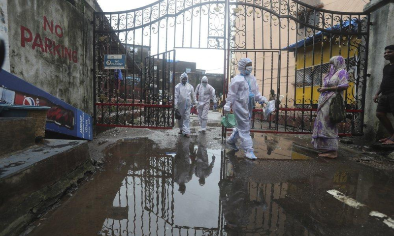 Health workers leave after screening people for Covid-19 symptoms at a residential building in Dharavi, one of Asia's biggest slums, in Mumbai, India on Aug 7. &mdash; AP