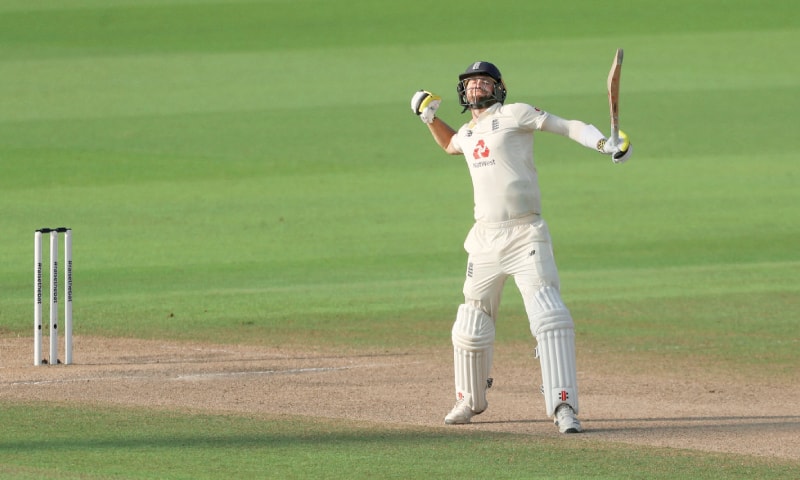 MANCHESTER: England all-rounder Chris Woakes celebrates after hitting the winning runs during the first Test against Pakistan at Old Trafford. — Reuters