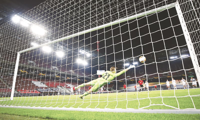 COLOGNE: Copenhagen goalkeeper Karl-Johan Johnsson fails to save a penalty shot by Bruno Fernandes of Manchester United during their Europa League quarter-final.&mdash;AP