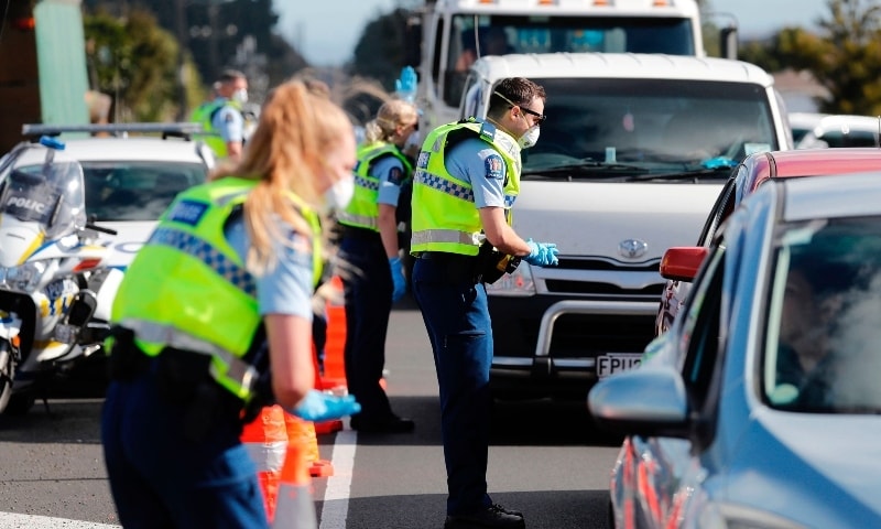 Police man a road block on the outskirts of Auckland as New Zealand's largest city moved to Covid-19 Alert Level 3 on August 12. — AP