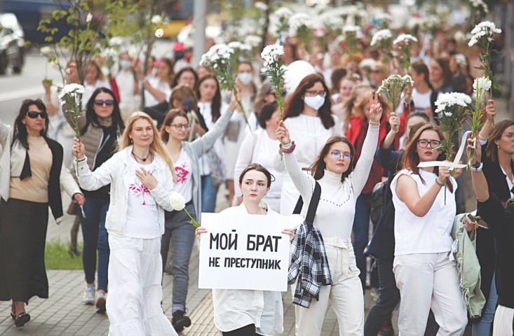 Minsk: A Belarusian woman carries a poster that reads “My brother is not a criminal” during a rally in solidarity with protesters injured in demonstrations  against the results of the country’s presidential election.—AP